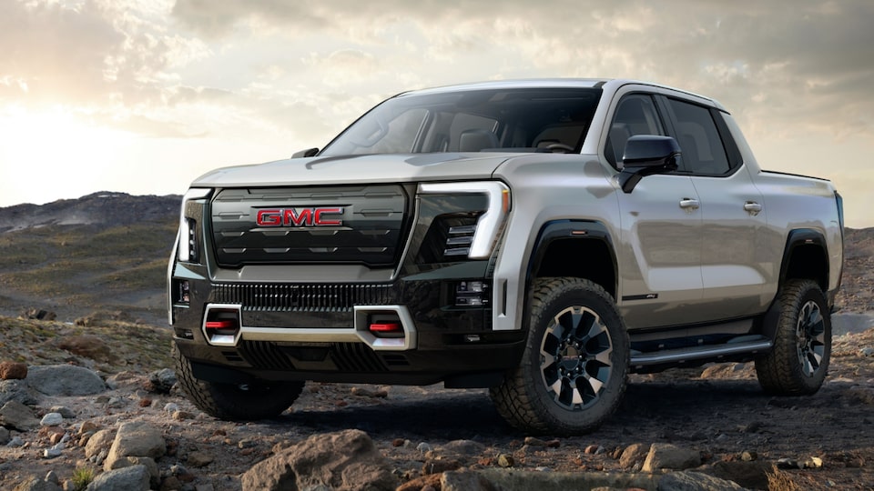 Front Three-Quarter View of the GMC Sierra EV AT4 Parked on a Rocky Path