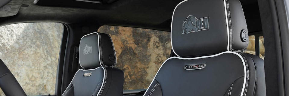 Close-up of the Sierra HD AT4X AEV Badging on the Interior Black Leather Head Restraints