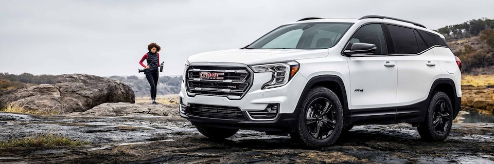 Woman walking to her 2022 GMC Terrain AT4