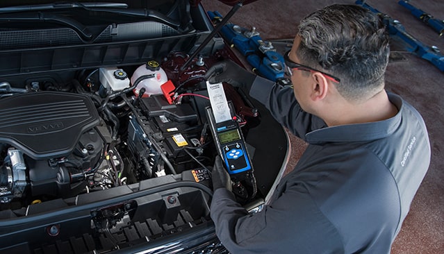 Certified GMC technician checking battery health