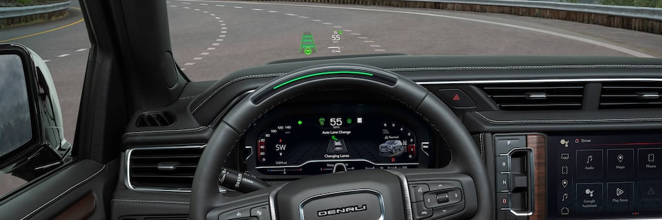 Close-up View of the Steering Wheel and Auto Lane Change Feature Being Used on the Heads Up Display