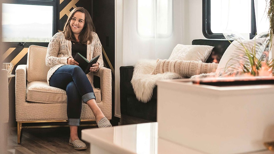 Woman Reading Book on Couch