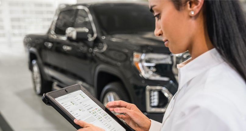 GMC Certified Service professional inspecting a GMC vehicle