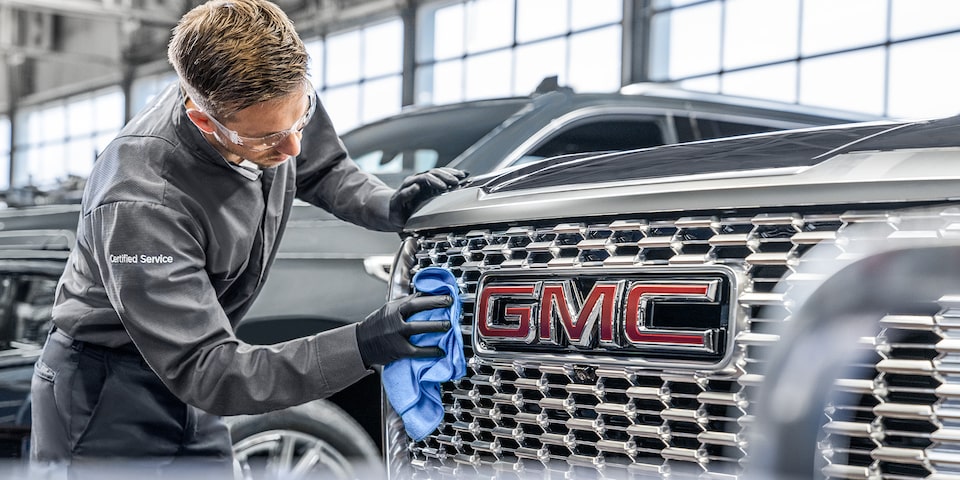 GMC Certified Service Wiping a Vehicle's Grille with a Cloth