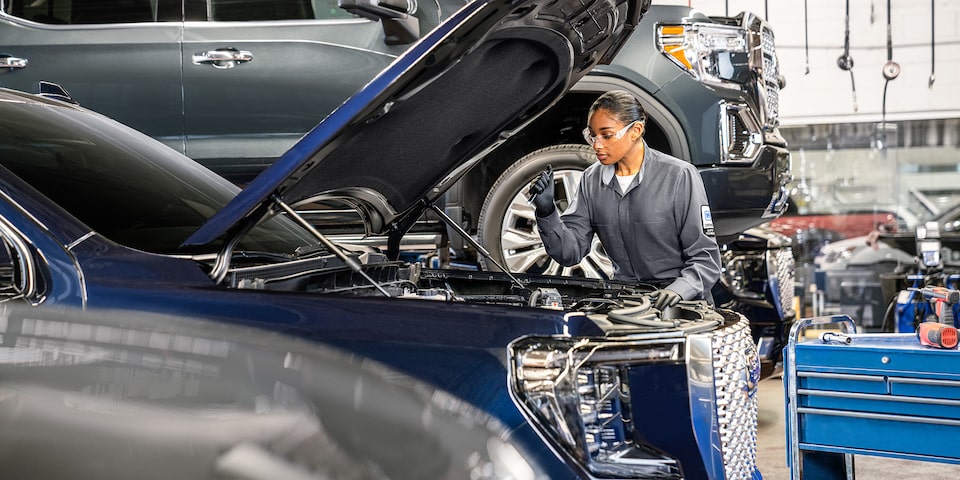 GMC Certified Service Technician Inspecting a Vehicle's Engine Bay