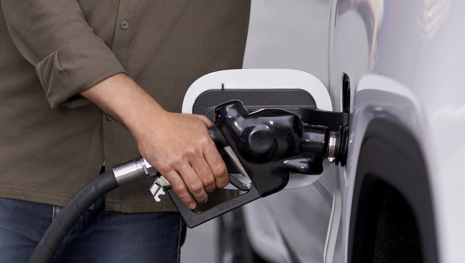 Woman Fueling Her GMC Vehicle Using Her GM Business Card