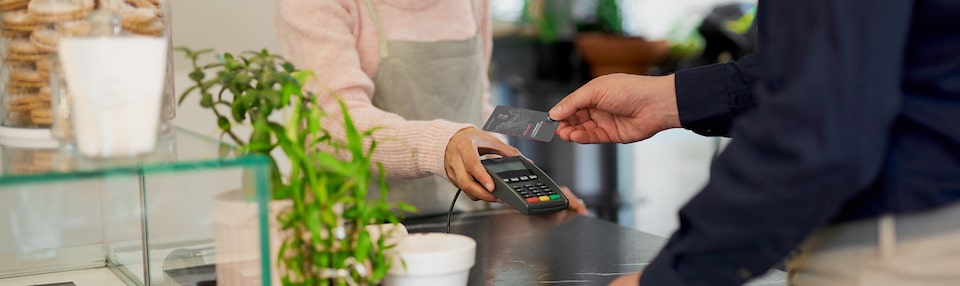 Man Using His My GMC Rewards Card at Coffee Shop to Earn Points