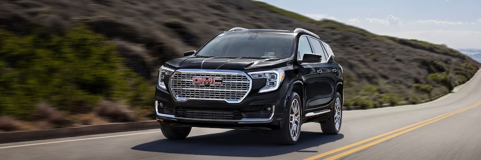 Front Three-Quarters View of a GMC Terrain Denali Driving on an Open Highway