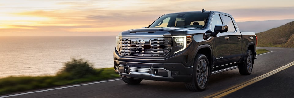 A GMC Sierra 1500 Truck Driving on a Highway With the Ocean in the Background