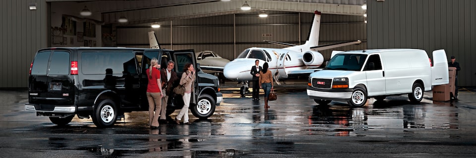 2023 GMC Vans in front of Airplane Hangar