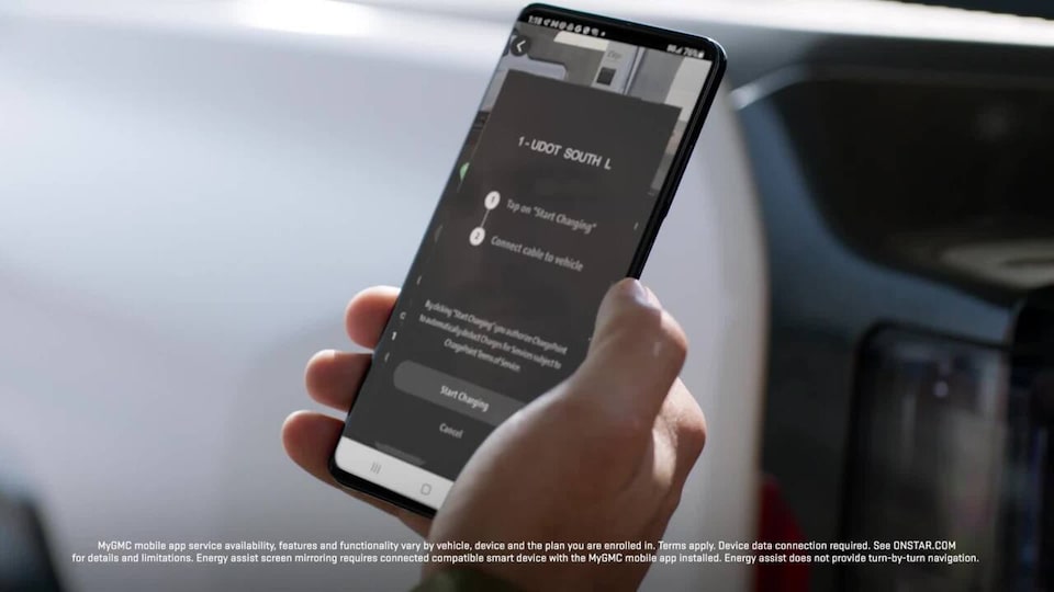A Person Holding a Phone with the GMC App Opened Showing Charging Option for the GMC Hummer EV SUV