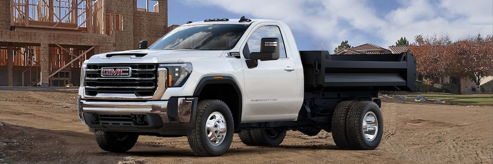 Front Three-Quarters View of a 2025 GMC Sierra HD Chassis Cab Work Truck Parked at a Job Site