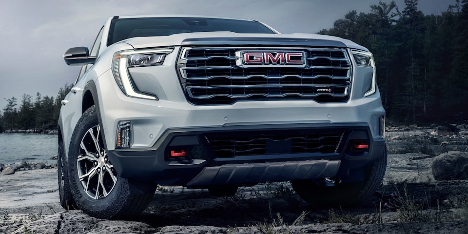 Close-up of the Grille on a 2024 GMC Acadia AT4 SUV Parked on Rocks