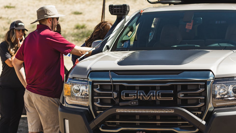 Pedestrians Viewing a GMC Pickup Truck at Overland Expo 