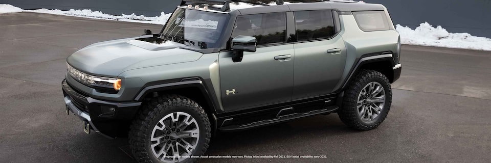 Front side view of GMC Hummer EV sitting in a snowy parking lot