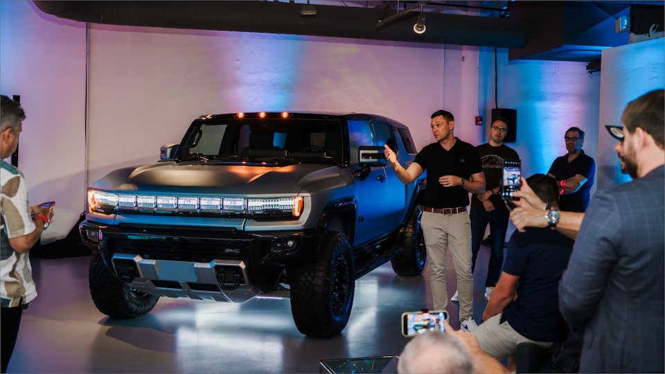 A GMC Employee Showing off the GMC HUMMER EV to People