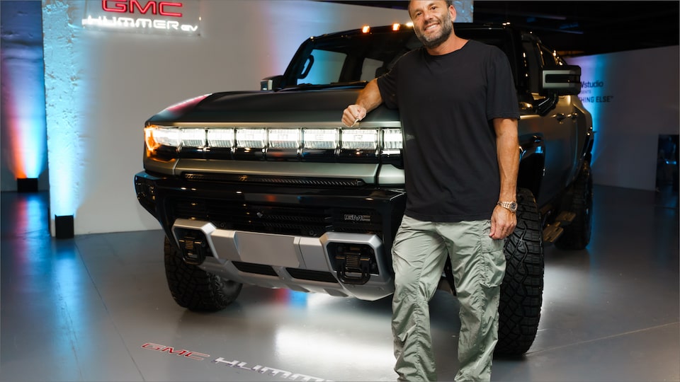 A Man Leaning on a GMC HUMMER EV