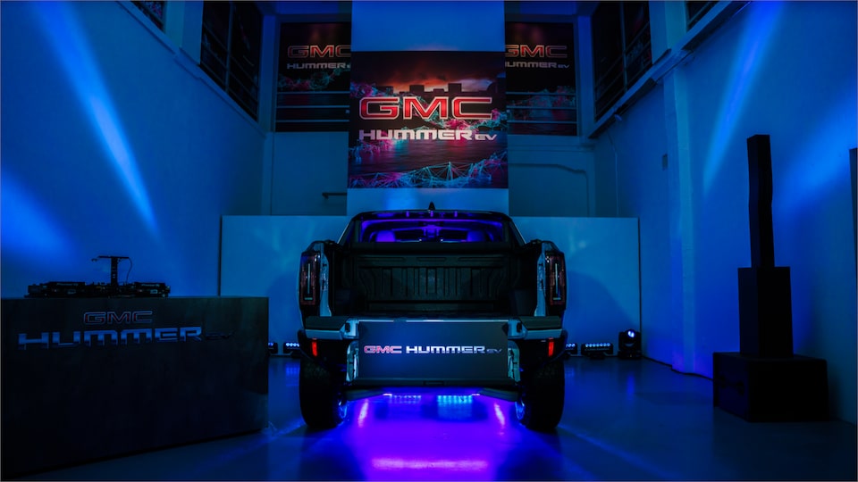 A Lit Up Showroom Containing the GMC HUMMER EV