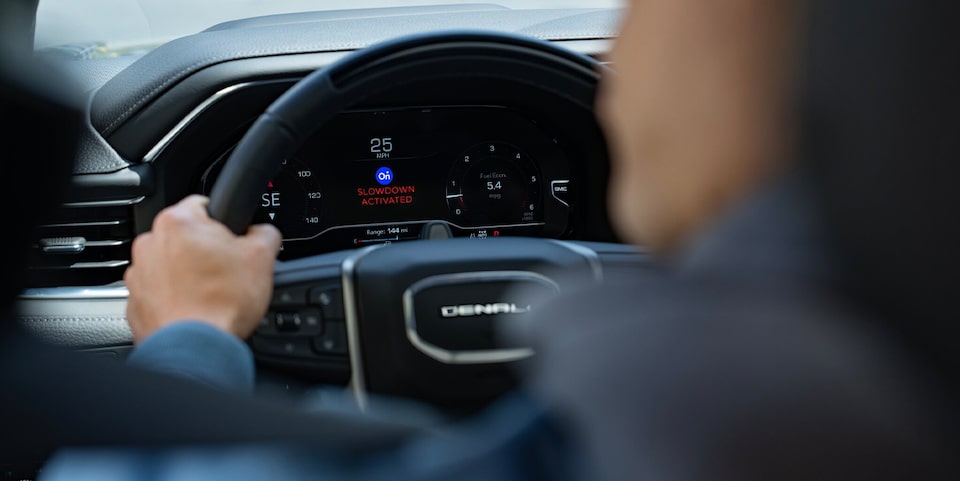 Back Seat View of a Person Holding the Steering Wheel of a Denali