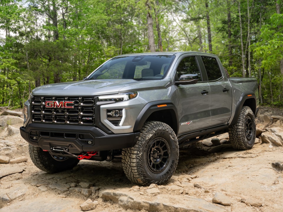 Front Three-Quarters View of a GMC Truck Parked in a Forest