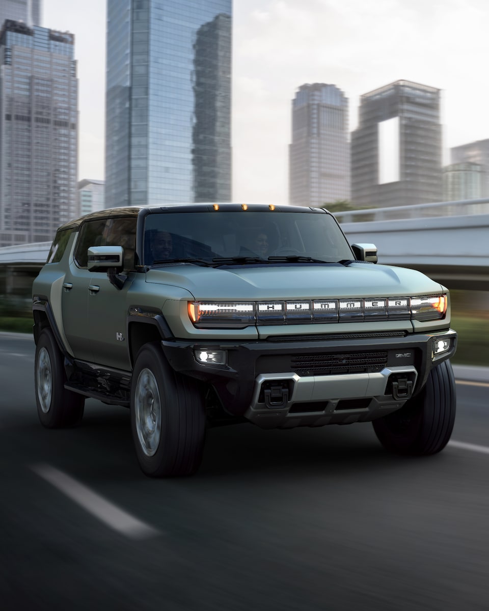 A Hummer EV SUV Driving Through a City