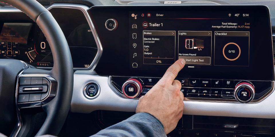 A Driver Using the GMC Canyon Infotainment System