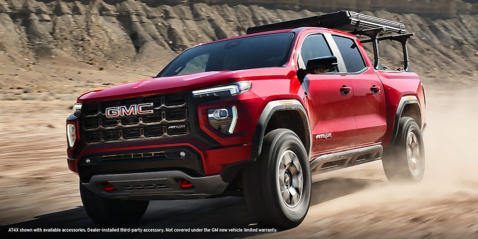 The Red GMC Canyon AT4 Driving Off-Road Kicking Up Dirt