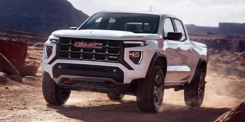 A 2024 GMC Canyon AT4 Driving Off-Road on Dirt