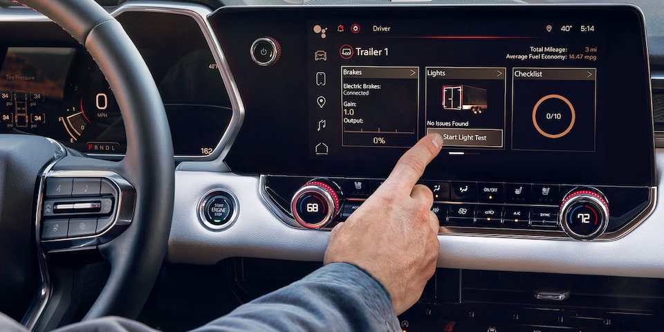 A Person Using the In Vehicle Trailering App on the 2024 GMC Canyon AT4