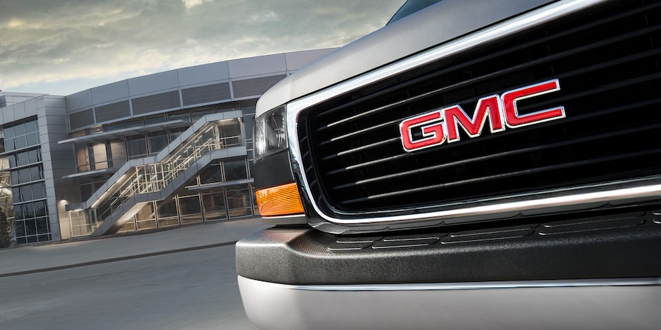 Close-Up on the Front Grille of the GMC Savana Passenger Van