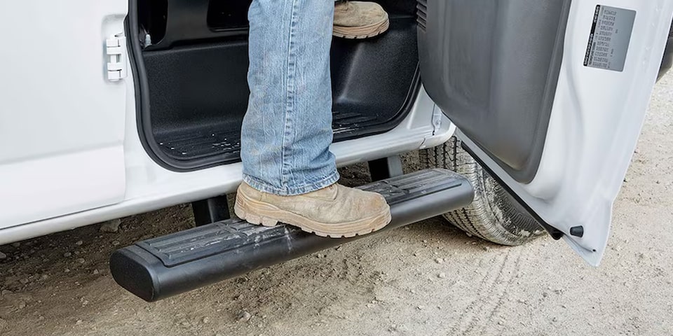 Close-Up on a Person Using the Step-Assist on the GMC Savana Cargo Van