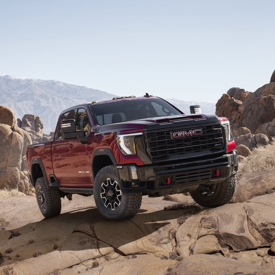 A Parked GMC Sierra HD in Red with Mountains in the Background