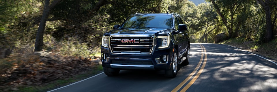 2024 GMC Yukon Driving Down a Scenic Road