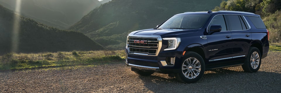 Wide View of the 2024 GMC Yukon Parked With Mountains in the Background