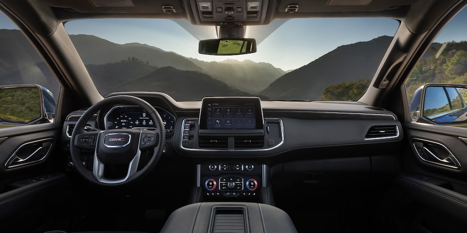 A Rear Passenger's View of the Front Interior of the GMC Yukon SLE/SLT