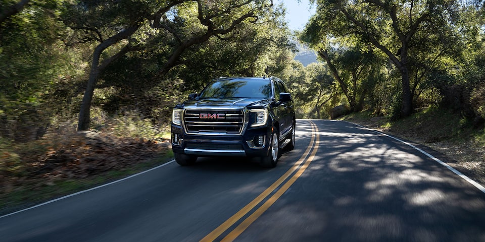 2024 GMC Yukon Driving Down a Scenic Road