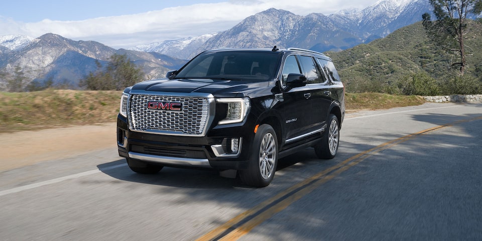 The Black GMC Yukon with Adaptive Suspension Driving On-Road