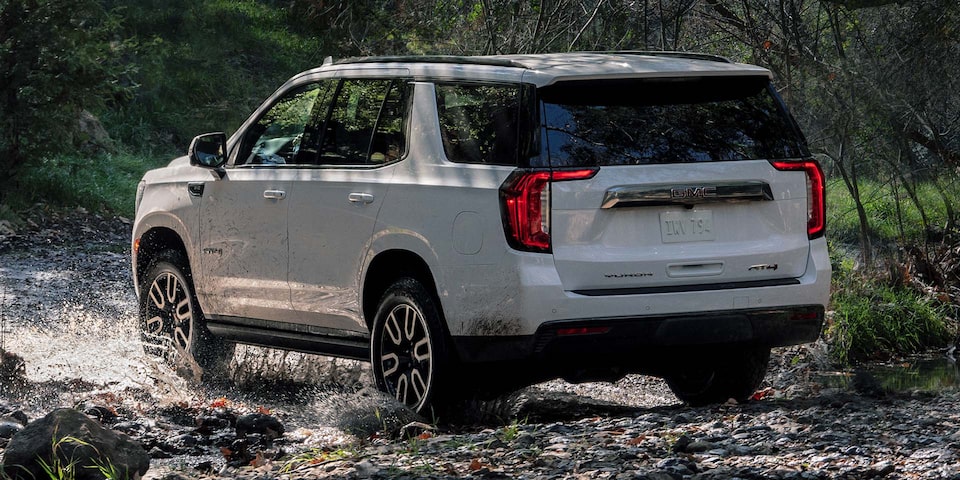 The White GMC Yukon Driving Off-Road