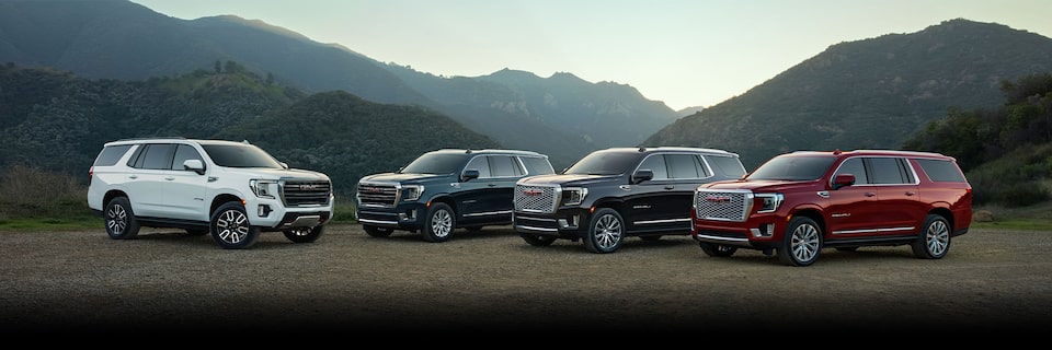 A Lineup of the 2024 GMC Yukon Trims Parked