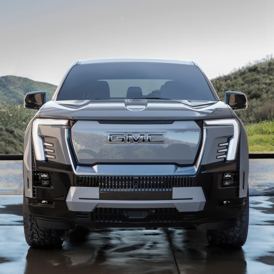 Front Head On View of the GMC Sierra EV Truck With Trees in the Background