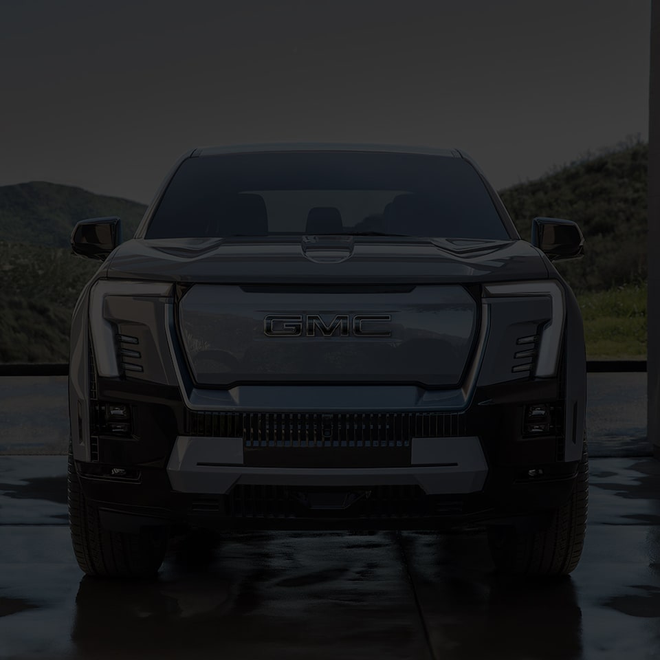 Front View of the Sierra EV Pickup Truck Parked with Rolling Hills in the Distance