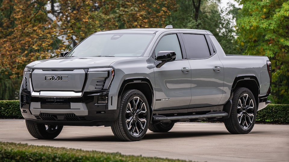 Front Three-Quarter View of the GMC Sierra EV Pickup Truck Parked in a Driveway